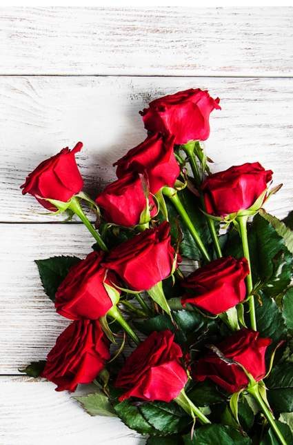 Red Roses On A Wooden Table — Experienced Florists in Toronto, NSW